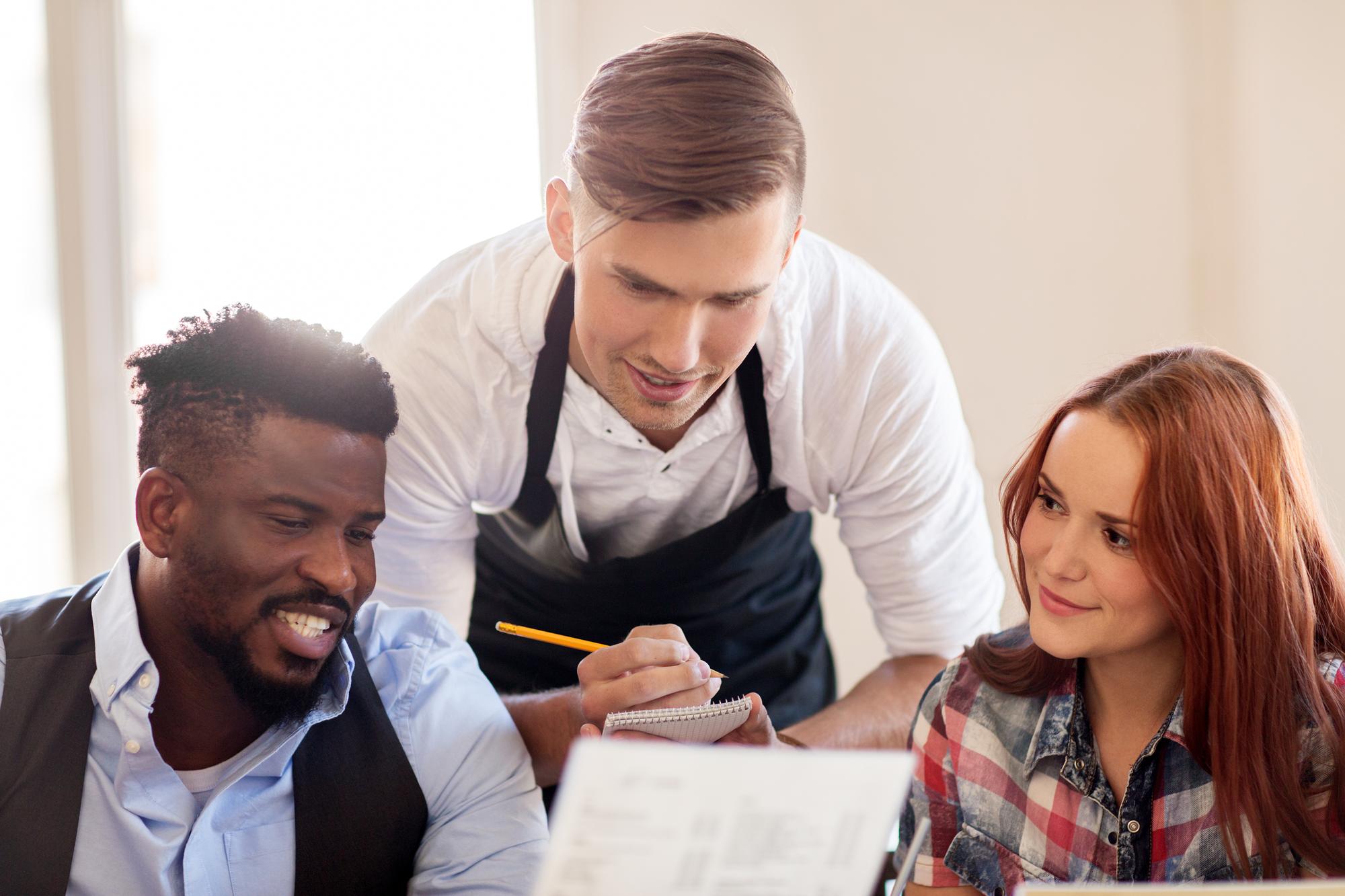Team tasting and taking notes at a long table